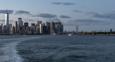 Fototapeta premium Lower Manhattan skyline at sunset viewed from the water.