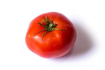 a red tomato lies on a white background