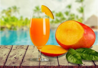 Fresh beautiful delicious mango juice. Concept of smoothie cold drink in a glass cup