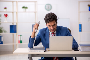 Young male employee working in the office