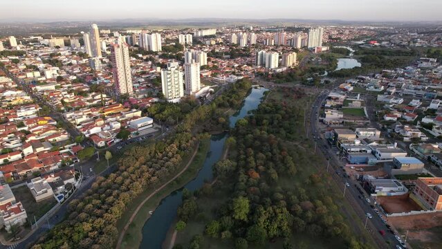 Indaiatuba Ecological Park. Beautiful park in the city center, with lake and beautiful trees and houses. Aerial view.