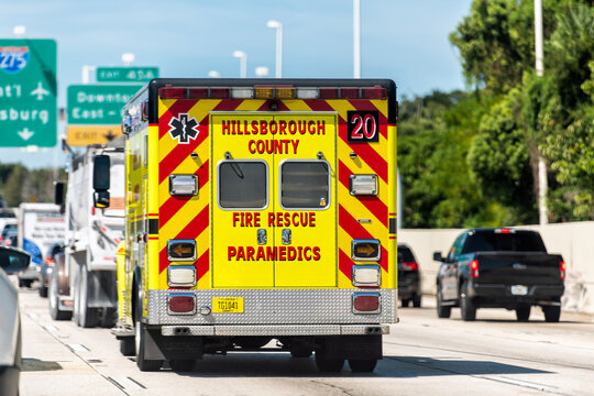Tampa, USA - October 4, 2021: Road street interstate highway i275 for St Petersburg sign in Florida with Hillsborough County Fire Rescue Paramedics Ambulance in traffic jam