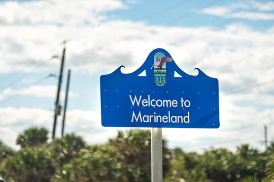 Marineland, USA - October 19, 2021: Welcome to Marineland blue sign in north Florida palm coast with River to Sea Preserve beach on sunny day