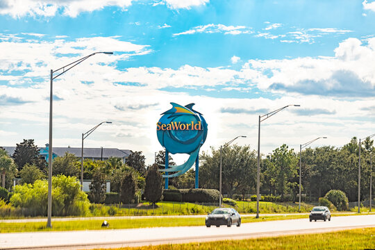 Orlando, USA - October 19, 2021: Billboard road highway sign for Seaworld Theme entertainment amusement attraction park in Florida city with roller coaster rides, animal experiences