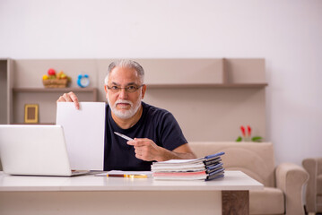 Old male employee working from home during pandemic