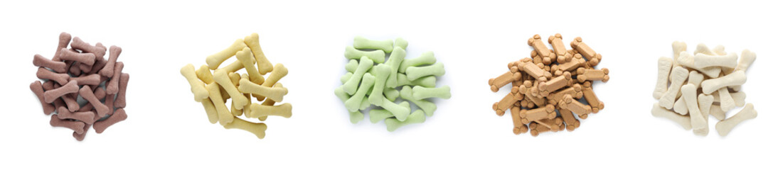 Set with piles of different bone shaped dog cookies on white background, top view. Banner design