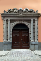View of house with beautiful arched wooden door. Exterior design