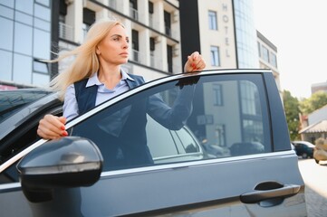 Fototapeta na wymiar Nice business woman, standing near automobile.