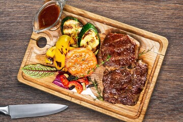 Tasty meat dish served on wooden board