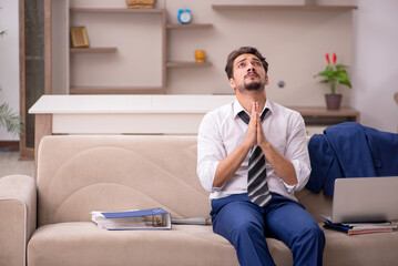 Young male employee working from home during pandemic