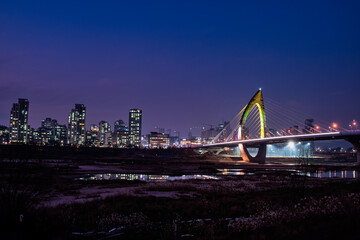 Scenic view of bridge and city scape against sky during sunset