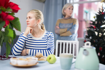 Elderly mother quarreling with daughter during christmas time at home