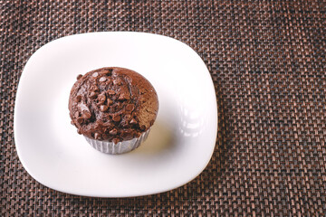 delicious chocolate flavor cupcake with homemade chocolate chips placed on a white plate great for dessert