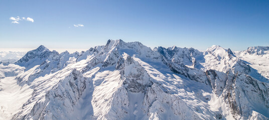 Fototapeta na wymiar Amazing mountain range covered with snow against a blue sky 