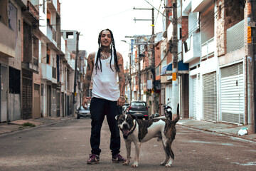 latin mexican gangster with his pitbull dog on the street - obrazy, fototapety, plakaty