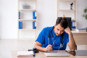 Young male doctor working in the clinic