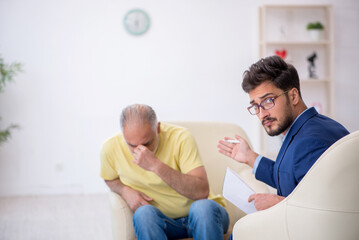 Old man visiting young male psychotherapist