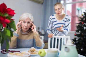 Adult daughter, who came to visit before Christmas, quarrels with her mature mother, trying to...