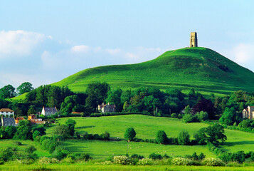 Ruined church tower tops the ancient pagan mystical hill of Glastonbury Tor above the village of Glastonbury, Somerset, England. © David Matthew Lyons