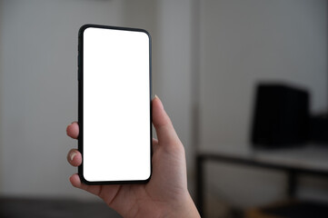 Close up women using a smartphone with an empty white screen at home.