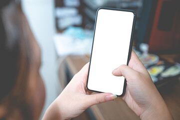 Close up business women using a smartphone with an empty white screen at the office workplace.