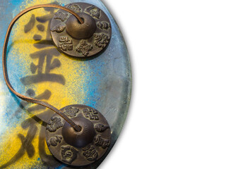 Top view of Reiki symbol with Tibetan bell and white background. (Translation: Reiki, vital energy)