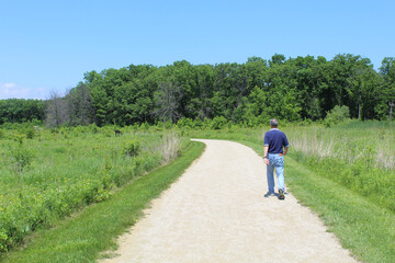 Man walking on a trail at Middlefork Savanna Forest Preserve in Lake Forest, Illinois