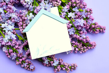 Spring summer background. lilac, figure of a house on a lilac background. Color of the year 2022.
