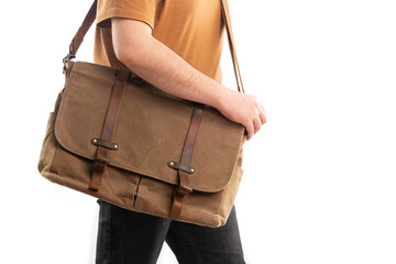 Brown suede shoulder bag, yellow T-shirt and white background jeans carry laptop and documents on a man's shoulders. Satchel, male suede handmade briefcase.
