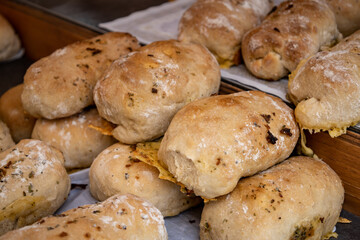 Rich homemade bread with fried onions inside. Flour-based food.