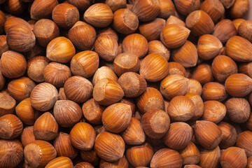 Countless brown hazelnuts in the market.