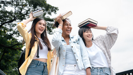 Diversity multi ethnic woman student holding books and looking at natural outdoors at park. Prepare for college and university concept.Informal national education .looking for scholarship opportunity.