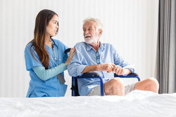Caregiver nurse take care a Senior patient sit on wheelchair. Nurse helping senior Man	
