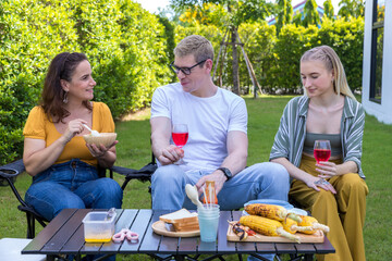 Family enjoy backyard barbecues party. People hanging out at home party. Family having a barbecue...