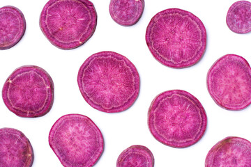 Purple potato slices isolated on white background, top view, flat lay.