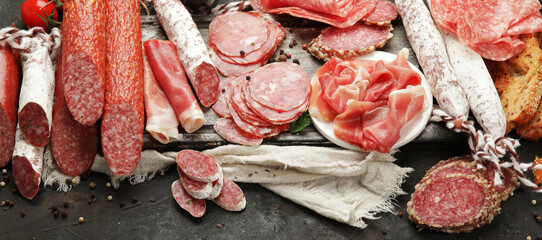 Sasusages assortment on dark background.