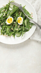 Fresh dandelion salad on light background.