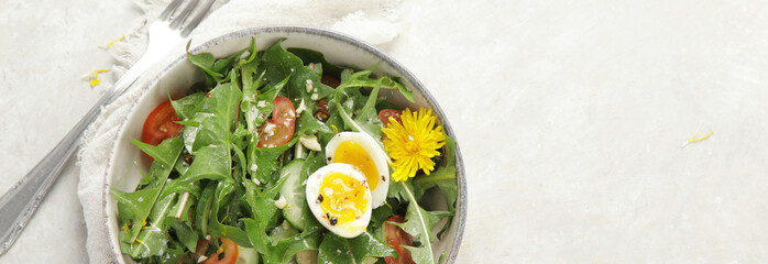 Fresh dandelion salad on light background.
