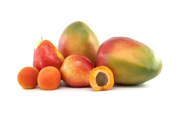 Whole and halved ripe apricot, pear and mango fruit