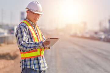 Fototapeta premium Senior Engineer Asian man working with tablet technology construction, construction worker with tablet computer and wearing construction uniform