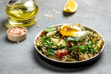Quinoa buddha bowl with avocado, egg, tomatoes, spinach and sunflower seeds on a light background. Homemade food. Healthy, clean eating. Vegan or gluten free diet, Long banner format. top view