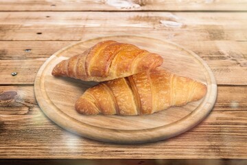 Tasty sweet breakfast croissant on the desk
