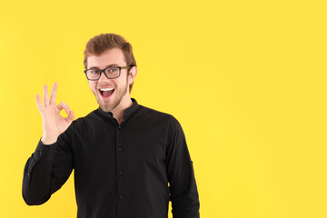 Concept of people, young man on yellow background