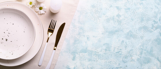 Beautiful table setting with flowers on light blue background with space for text