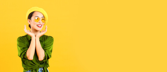 Fashionable Asian woman on yellow background with space for text