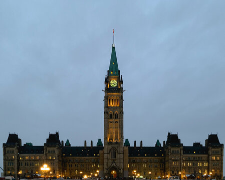 View Of The Canadian Parliament Lit Up On A Calm Winter Evening With Cloudy Sky