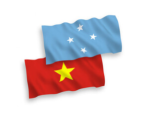 National vector fabric wave flags of Federated States of Micronesia and Vietnam isolated on white background. 1 to 2 proportion.