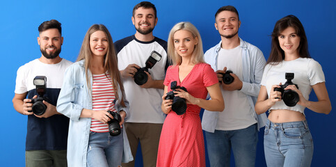 Fototapeta Group of young photographers on blue background obraz