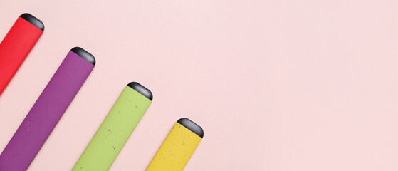 Modern electronic cigarettes on pink background with space for text