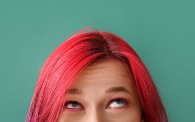 Beautiful woman with bright hair on green background, closeup